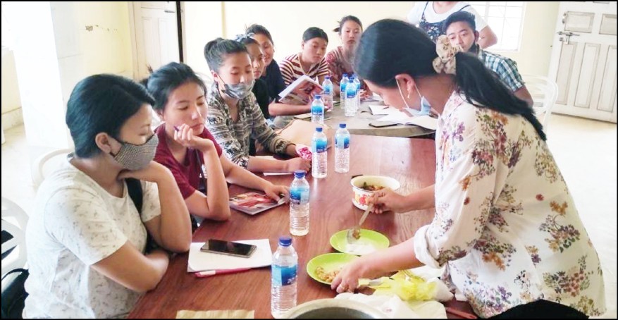 Participants of the training programme observe as a resource person demonstrate pickle making techniques in Jalukie. (Photo Courtesy: ATMA Peren)